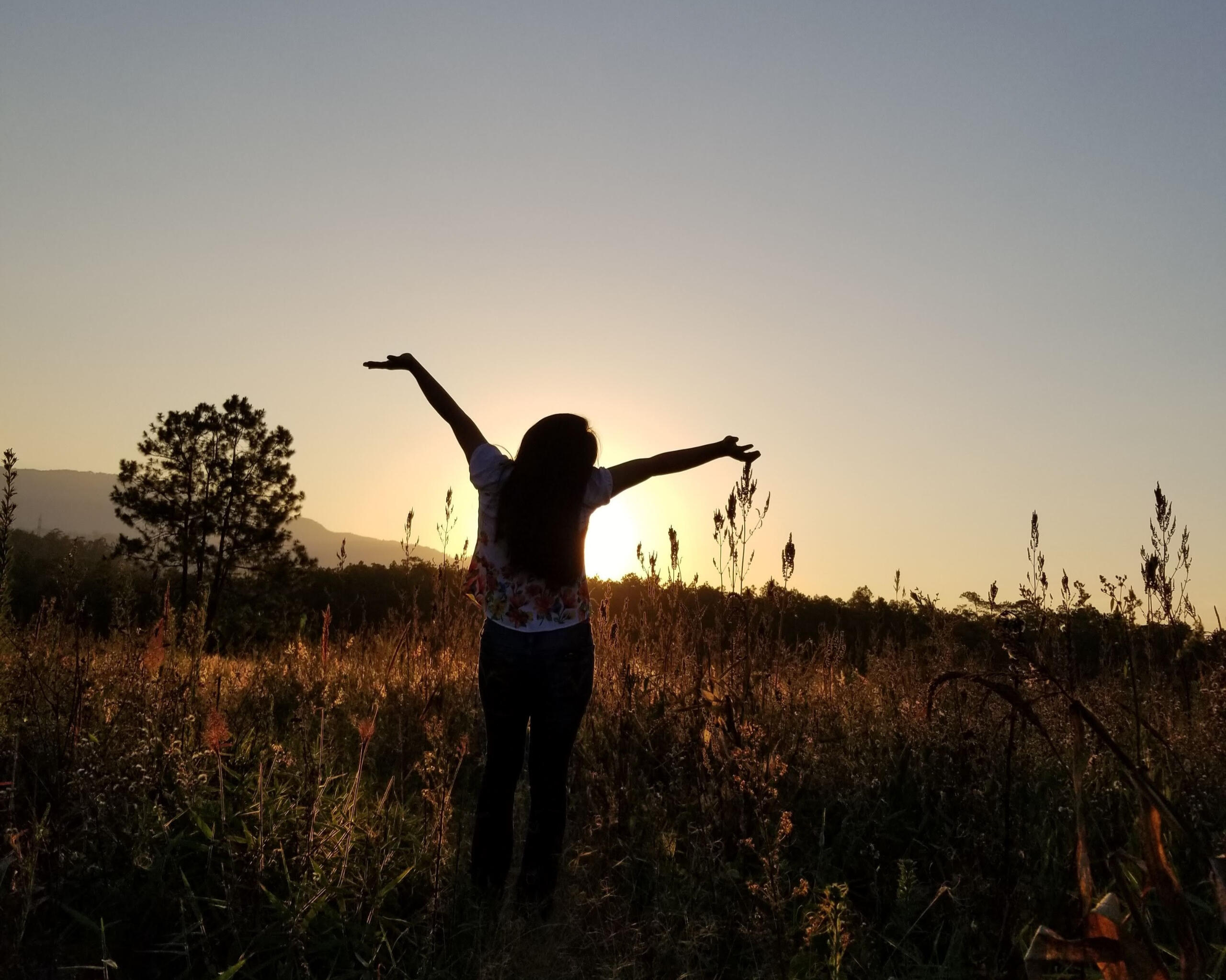 Woman with arms outstretched showing freedom